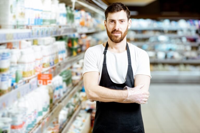 Worker in the supermarket with dairy products